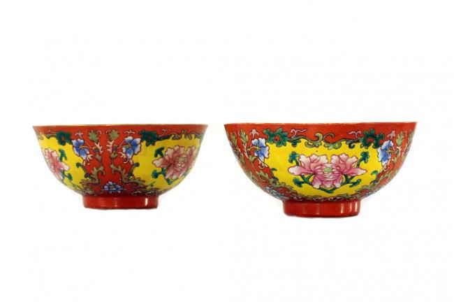 PAIR OF CHINESE FAMILLE ROSE BOWLS IN CORAL GROUND: D: 4 3/4 in. (13cm), raised and enameled with floral motif in four yellow panels, Dao Guang mark on the cylindrical base