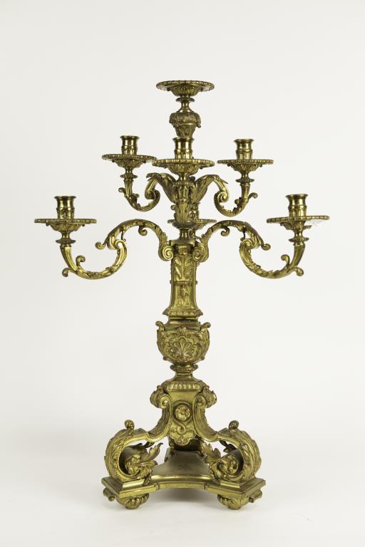 GILT BRONZE SEVEN-ARM CANDELABRUM: Mounted on a gilt bronze plinth, with three legs of rococo design. Extended with a column of the same design in the center that is flanked by seven-arm candelabrum. H: 27 3/4 in.