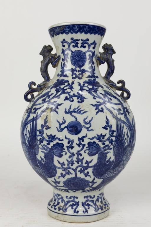 CHINESE BLUE AND WHITE MOONFLASK: Flanked by two chilongs on the neck. Six-character mark to read Qianlong on the bottom.