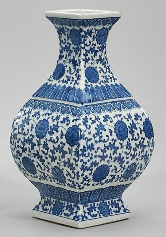 ANTIQUE CHINESE BLUE AND WHITE SQUARE VASE: Beautifully painted with blossoming flowers and scrolling leaves all around the vase. Six-character mark on the bottom to read Qianlong.H: 10 3/4 in.