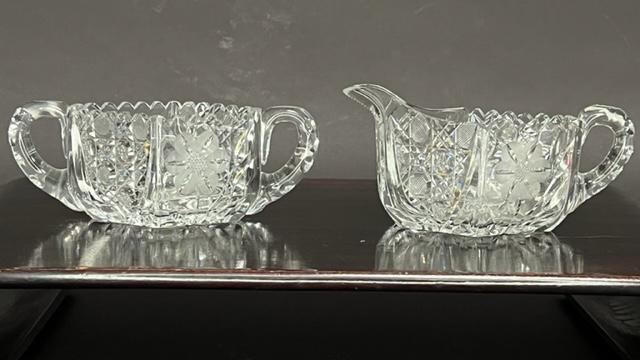 SET OF TWO CUT GLASSES: CREAMER & SUGAR BOWL: Flanked by handles. One a creamer, and the other a sugar bowl in brilliant design