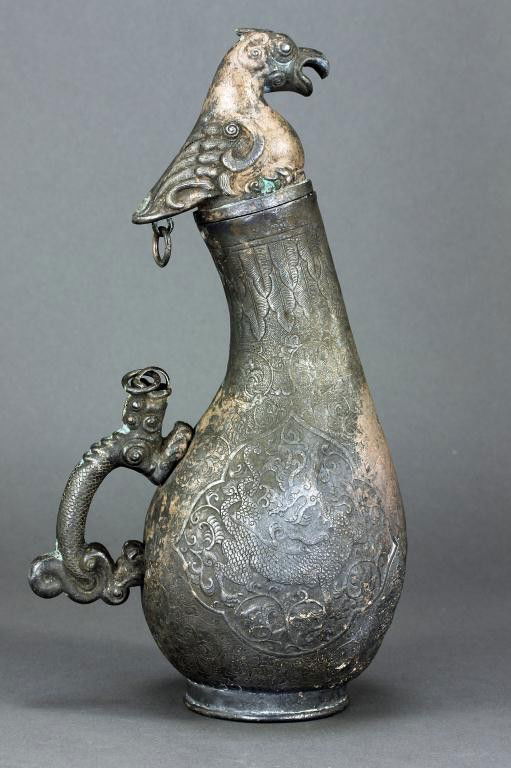 ANTIQUE 17TH CEN. CHINESE GOURD SILVER WINE VESSEL: H: 9 7/8 in. (25cm), with detailed carving of a phoenix head stopper that connects to an applied beast scroll handle with a chain, the body finely chased with dragon in cartouche on two sides against