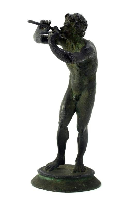 ORIENTAL BRONZE FIGURE OF A NAKED MAN: H: 5 1/4 in. (13cm), possibly belonging to an ethnic tribe, the naked man holds two blow darts on his mouth