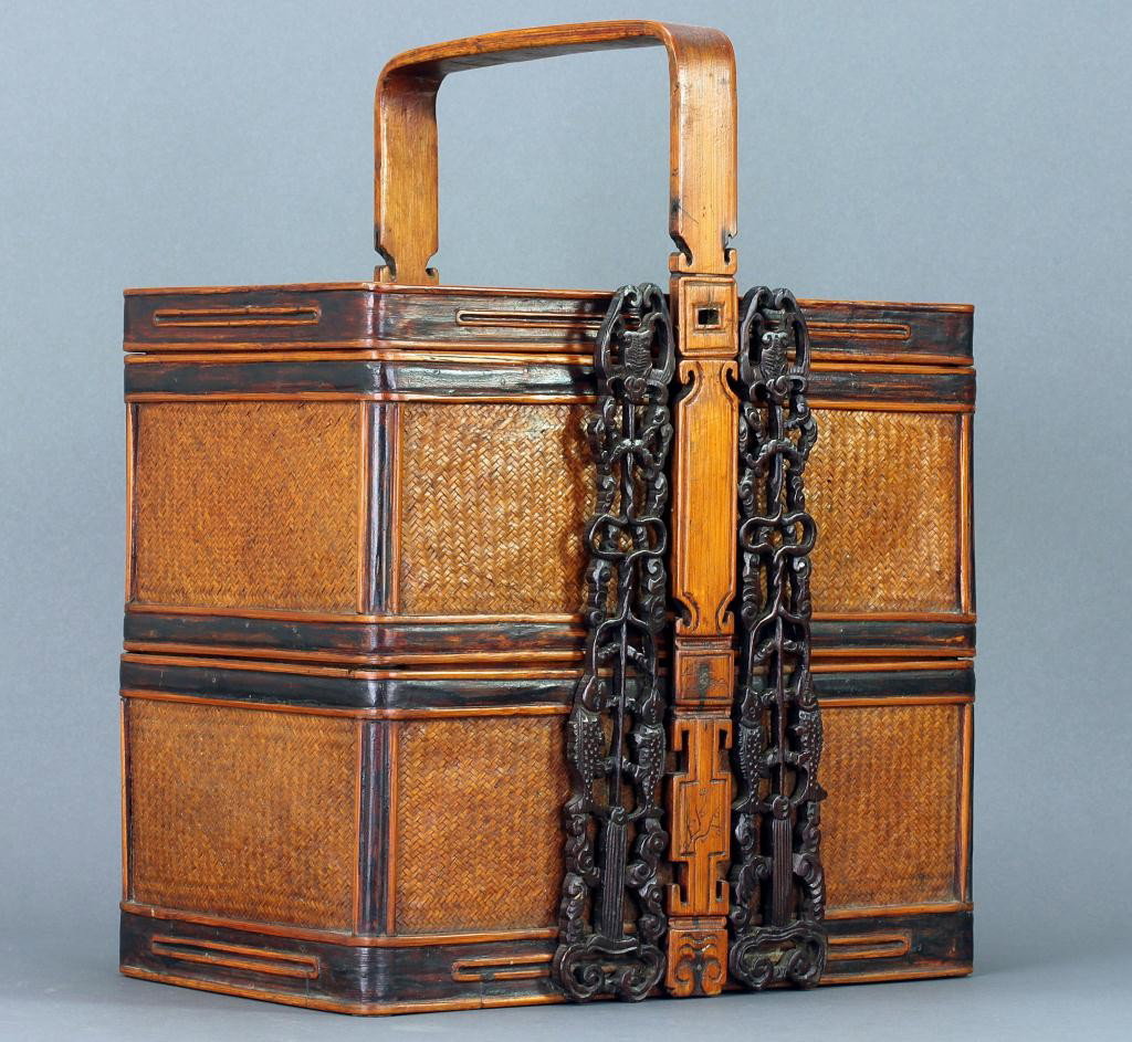 ASIAN RECTANGULAR TRAVELING BOX: L: 10 in. (25cm) x W: 7 1/4 in. (18cm) x H: 12 1/2 in. (31cm) , with two compartments having woven rattan design in a fitted case and holder decorated with openwork vertical carving of bats, scrolls a