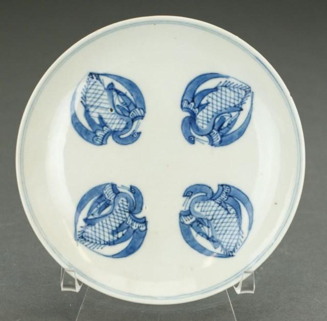 ANTIQUE JAPANESE BLUE AND WHITE SMALL PLATE: With four stylized cranes on the interior with blue double band around the inner and outer rim, Two character mark on the bottom. D: 5 1/4 in.