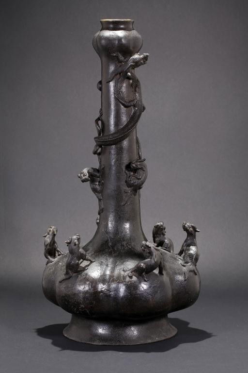 ANTIQUE CHINESE LONG-NECKED BRONZE VASE: H: 20 1/8 in.(51.1cm), globular garlic body and garlic neck, with six chilongs on each clove watching an ascending ferocious dragon while securing a pearl in its claw and the three chilongs below it,