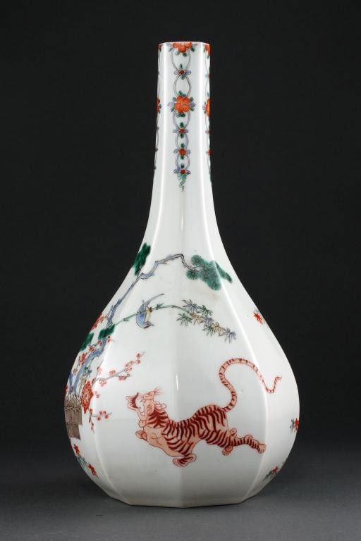 KAKIEMON-DESIGNED PORCELAIN VASE: pear-shaped octagonal body with long bottle neck, hand-painted with flowering branches and a tiger, on white ground. H: 11 1/4 in.