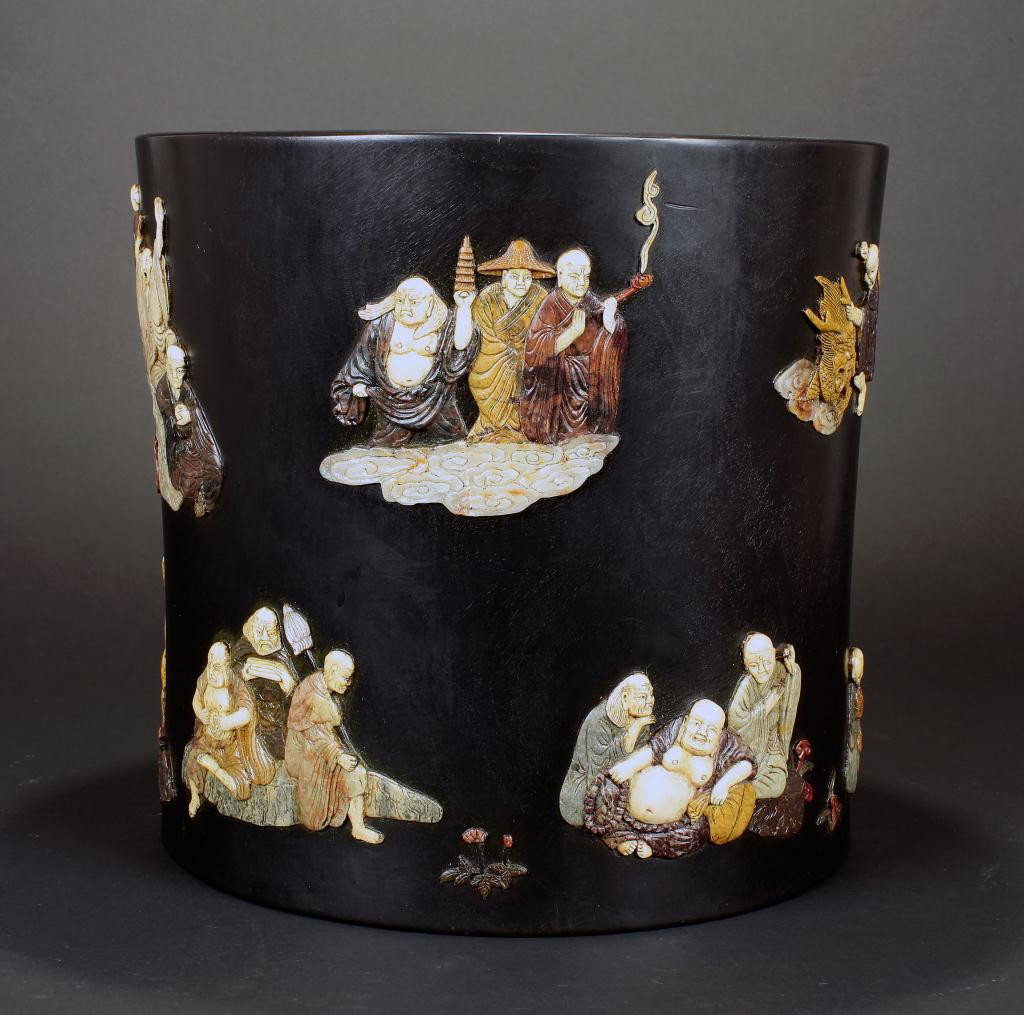 CHINESE INLAID AND EBONIZED WOOD BRUSHPOT: of 18 Lohans. Diameter: 12 1/4 in. (31.1cm), L:11 1/2 in. (29.2cm)