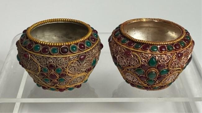 A PAIR OF TIBETAN HAND-MADE JEWELED CUPS: Filigree gilt and band of bejeweled stones.