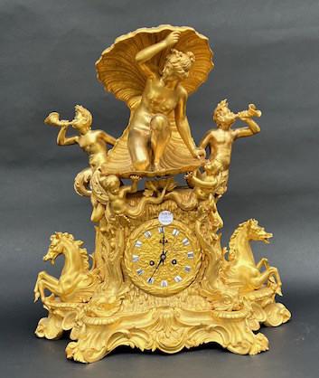 A LARGE INTRICATE GILT BRONZE MANTEL CLOCK: Mermaid underneath a shell with cherubs on her sides atop galloping horses. Size: H: 21 3/4 in. L: 19 3/8 in.