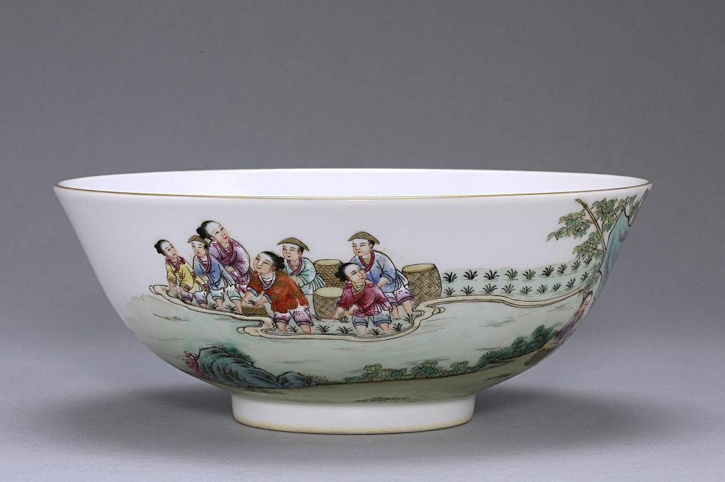 CHINESE FAMILLE ROSE PORCELAIN BOWL: Republic period. Enameled to depict daily life of villagers during harvest season. Seal mark to read Qianlong reign on the base. Diameter: 7 in.(18cm) x H: 2 7/8 in. (7.5cm)