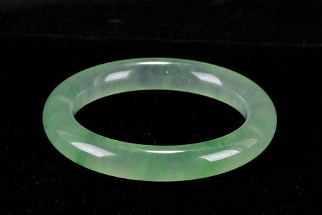 EXQUISITE BURMESE LIGHT GREEN JADE BANGLE: The bangle is in a very beautiful transparent light green color. Diameter: 3 1/4 in.(8.5cm)