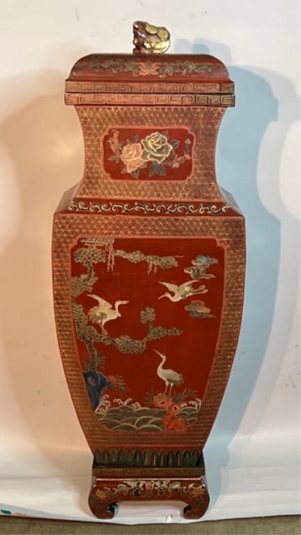 GILDED AND CINNABAR-COLORED CHINESE VASE: One panel depicts of a phoenix hovering above a garden, and another panel depicts of cranes amidst trees motif. H: 54 1/2 in. L: 20 1/4 in. W: 10 1/4 in.