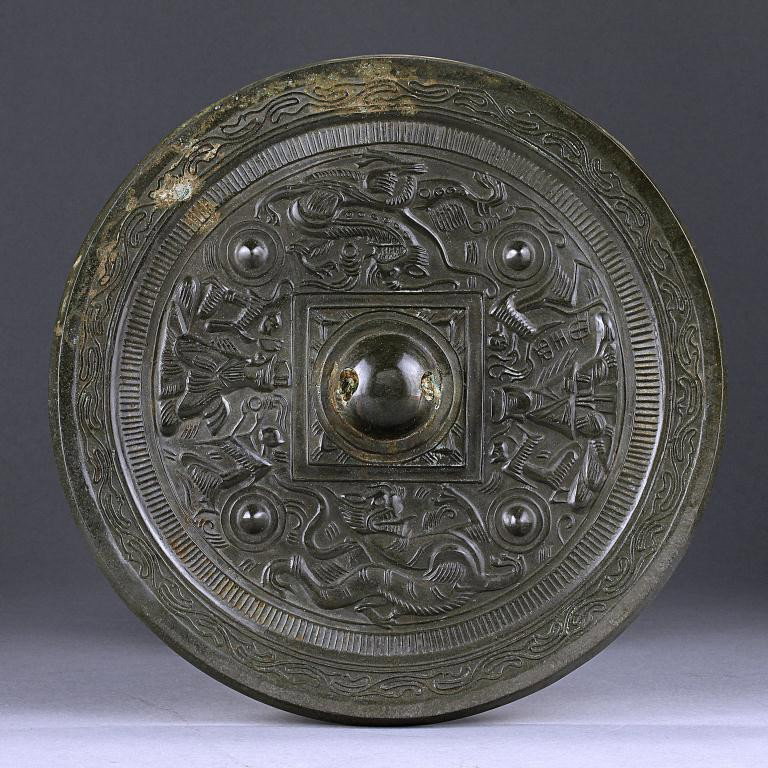 ANTIQUE CHINESE BRONZE MIRROR: The reverse is chased with a framed ball in the center which represents the sun, while the four corners have four small balls, representing the constellations. The Heavenly Queen Mother and King Fathe