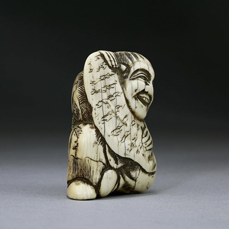 ANTIQUE JAPANESE CARVED IVORY NETSUKE OF A MAN: From the Private Collection of Harry Lawrence of Laguna Beach. holding a scroll. H: 1 1/2 in.(4cm)