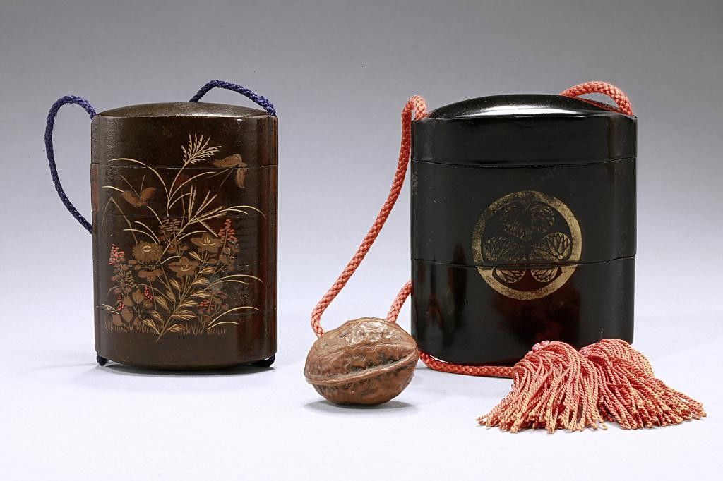 TWO JAPANESE ANTIQUE INRO: From the Private Collection of Harry Lawrence of Laguna Beach. One with a brown background and raised gilded enamel of a rooster in one side and raised enamel design of flowers on the other side. The