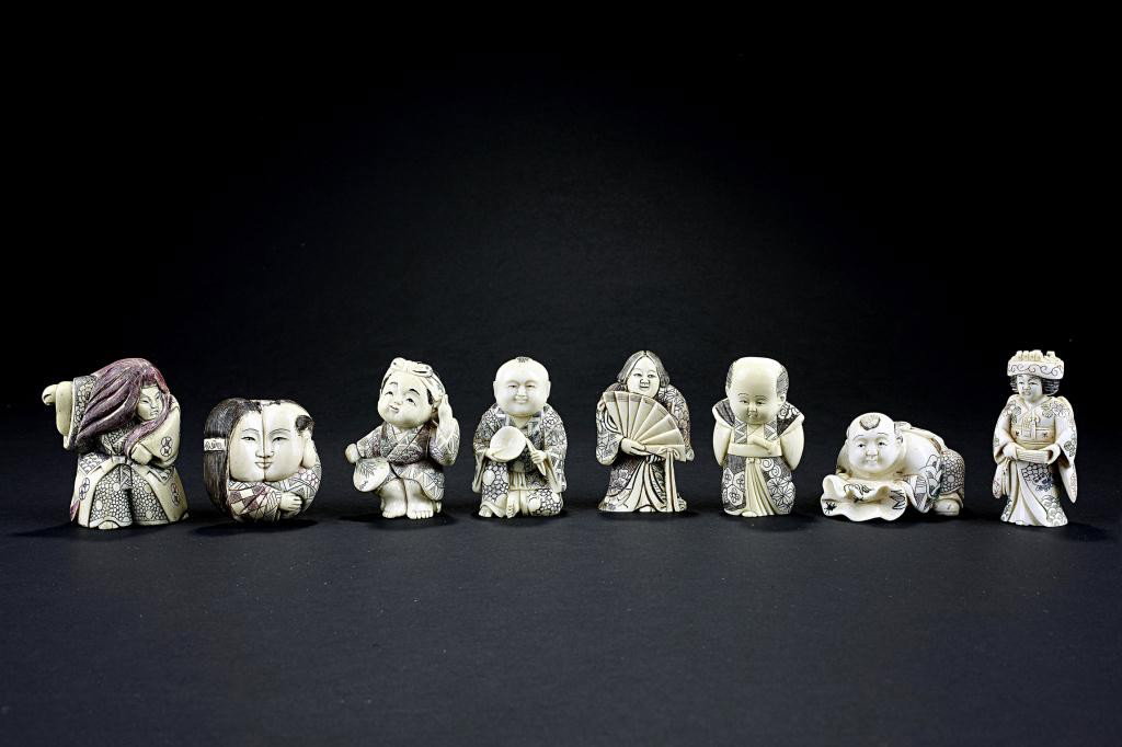 COLLECTION OF EIGHT (8) VARIOUS NETSUKES: From the private collection of a gentleman from California. A warrior or theater actor, a couple's faces put together as they embrace, a boy in a robe holding a fan, a plump woman holding out a fan, a