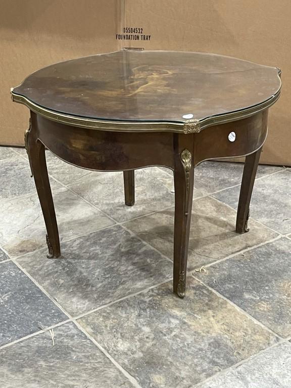 ANTIQUE ENGLISH HAND-PAINTED OCCASIONAL TABLE: Raised on four legs, with ormolu mounts. Beautifully hand-painted on the side, as well as on top of a lover's scene, with a glass top. H: 22 in. L: 30 in. Property from an exclusive, private collector