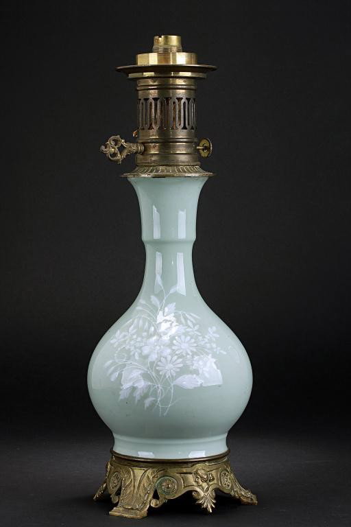 CHINESE CELADON BOTTLE VASE, SET AS A LAMP: 19th Century. Mounted on ormolu, the well potted globular body issues a slender flaring neck, lightly separated by a flange. H: 9 in.(23cm)