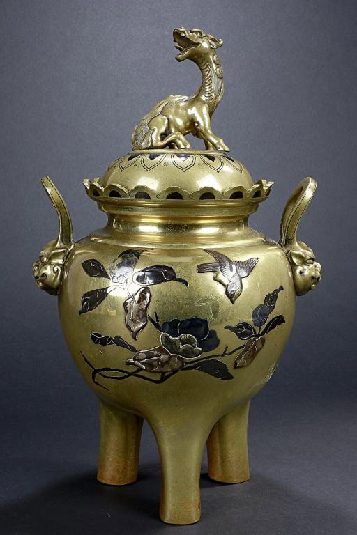 JAPANESE 19TH CENTURY BRONZE BASE KORO AND COVER: With silver and gold inlaid on garden setting in a globular body raised on three upright legs, flanked with loop handles issuing from lion's head to the sides, and a Hsi-hsi seating on the top of the 