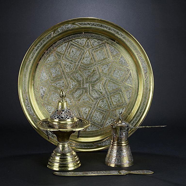 COLLECTION OF FOUR DAMASCUS ITEMS: Made of brass, copper and silver in-laid, the set includes coffee pot, letter opener, incense burner, and round tray. H: 9 1/2 in.(24cm)