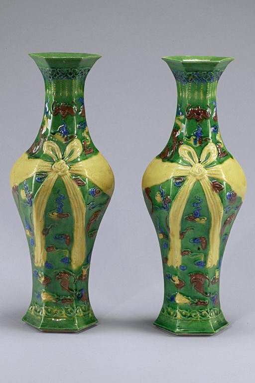 PAIR OF CHINESE GREEN GROUND VASES: Republic Period. Each of the phoenix tail-formed vases decorated with raised enamel of bats amidst clouds, and a yellow bow wrapped around the body on olive-green ground. H: 12 3/8 in.(31.5cm)