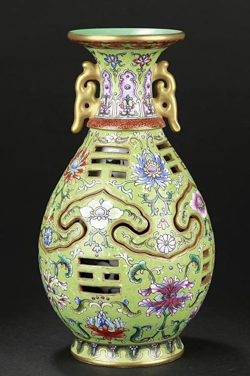 CHINESE RETICULATED PUZZLE VASE: A reticulated puzzle vase of ovoid-sectioned form having a flared rim and pierced body with broad ruyi lappets and I-Ching trigrams. The outer body decorated with various flowers and scrolling foliage