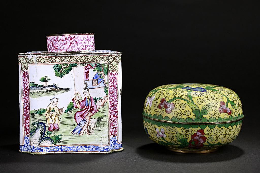 TWO CHINESE ENAMELED VANITY TABLE ACCESSORIES: One of a covered cartouche-shaped upright figural box, and the other a round box and cover with floral motif. H: 4 1/4 in.(11cm)