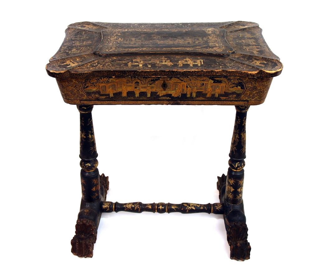 ANTIQUE CHINESE LACQUERED PAPIER MACHE WORK TABLE: With paneled rectangular top and having an extensive gilt chinoiserie design throughout, hinged and opening to reveal an interior fitted with lidded compartments and cubbyholes, raised on slender end 