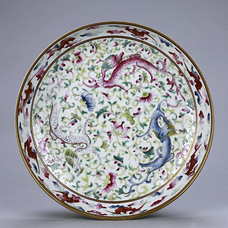 CHINESE FAMILLE ROSE 'QILIN' DISH: The interior colourfully hand painted with three chilongs amidst heaping and piling tendrils and lotus blooms surrounded by eight bats in between scrolling clouds, the exterior decorated with sprigs o