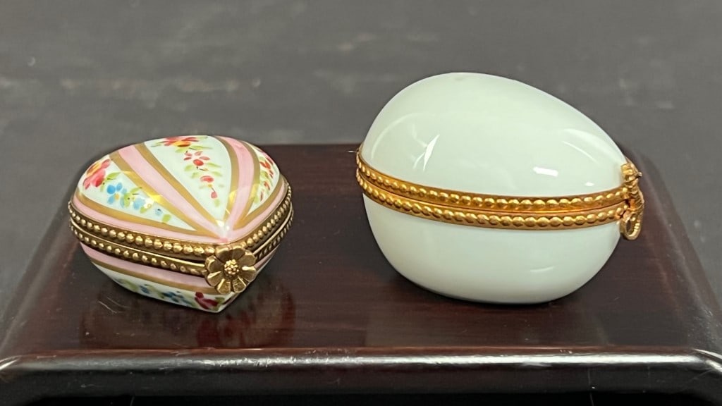 GROUP OF TWO PILL BOXES: One comes with a small glass bottle inside.