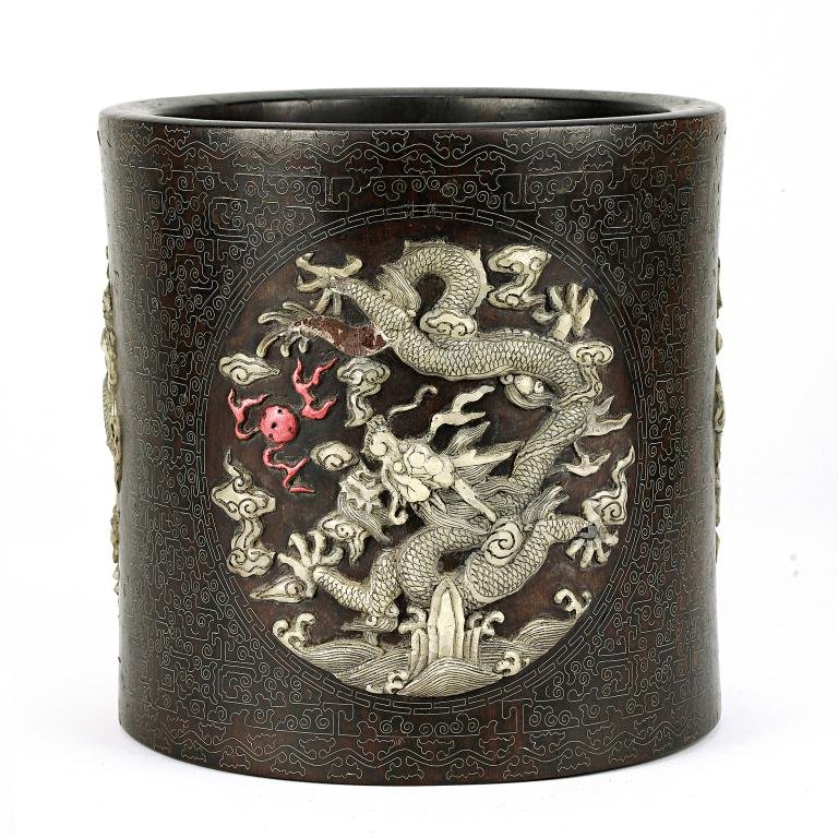 CHINESE WOODEN IN-LAID 'DRAGON' BRUSH POT: With four roundels of delicately carved soapstone inlay of five-clawed dragon in pursuit a flaming pearl amidst scrolling clouds and crashing waves, against an etched design ground lined with metal in