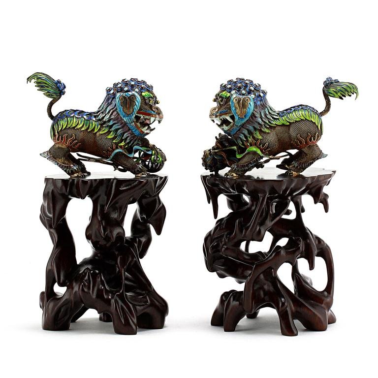 PAIR OF UNIQUE CHINESE SILVER ENAMELED FOO LIONS: From the Private Collection of a Gentleman from Miami.Each one of the gilded silver filigree lions lavishly enameled throughout its body resembling a body armour highlighting from its tail trailing a 