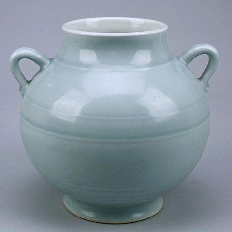 CHINESE LIGHT BLUE GROUND PORCELAIN HANGING JAR: Of bulbous form rising from a short splayed foot ring, flanked by two loop handles; six-character seal mark on the base to read Qianlong reign. H: 7 1/2 in.(19cm)