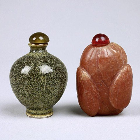 TWO CHINESE SNUFF BOTTLES: Of ovoid form rising to a short foot to a small flaring neck covered with creamy-white specs on olive green ground, with olive green dome cover, blue mark on the base; the other of irregular ovoid for