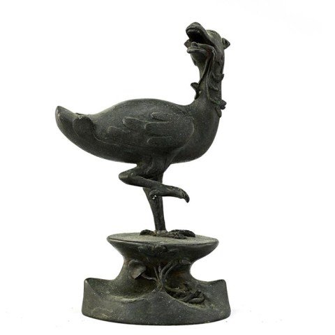 CHINESE BRONZE FIGURE OF A MYTHICAL BEAST: From the Estate of Mr. James Hawkins of California. Modelled on a raised plinth as a mythical beast with a dragon head and a body of a bird, standing with one foot raised, while holding a flower vine 