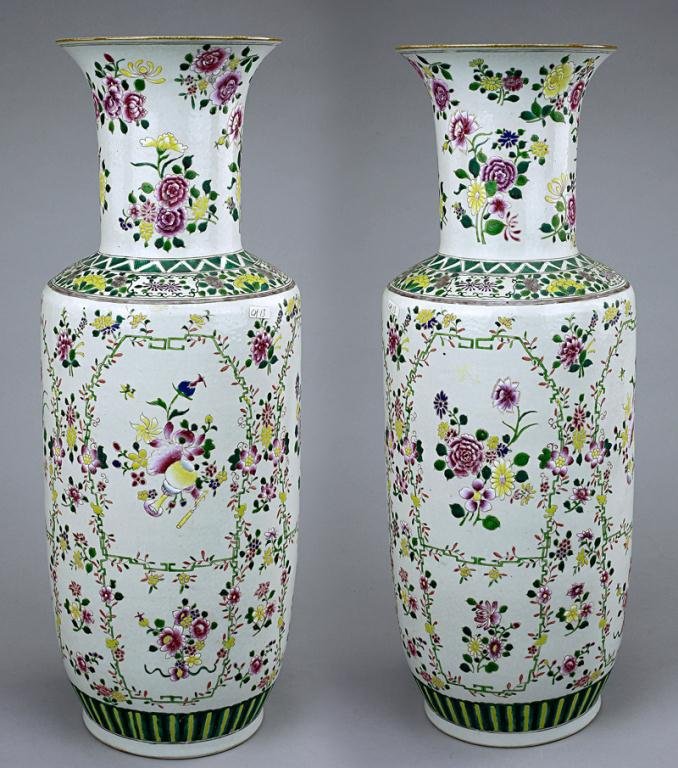 PAIR OF TALL CHINESE FAMILLE ROSE VASES: Both of baluster forms with canted shoulder and surmounted by a cylindrical neck, hand painted to the exterior with floral sprays bordered within floral festoons. Double ring mark on the base. H: 21 1