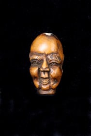 JAPANESE CARVED WOOD NETSUKE OF AN IMMORTAL HEAD