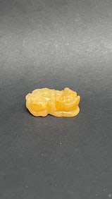 A RARE YELLOW JADE FIGURE OF A FOO DOG