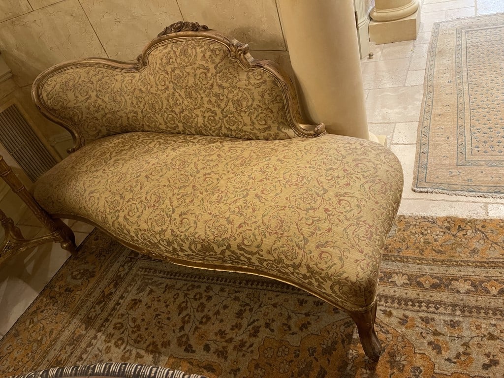 FRENCH GILTWOOD CHAISE LONGUE: With thick cushions upholstered in classic French fabric. H: 33 in. L: 67 in. W: 27 in. Property from an exclusive, private collector in Beverly Hills, California.