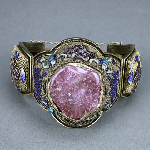 CHINESE SILVER ENAMELED BRACELET WITH ROSE QUARTZ: Rose quartz stone as a centerpiece, surrounded with alternating shou emblems, bats and ribbons, and scattered scrolling clouds, all on a mesh design ground. H: 3 in.(7.5cm)