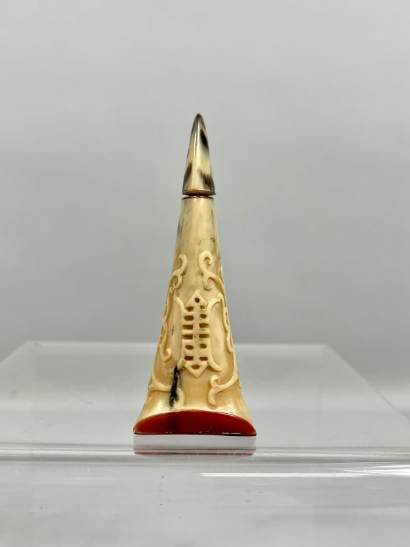 UNUSUAL CHINESE CARVED BONE SNUFF BOTTLE: Of a pyramid shape, carved with a "shou" symbol in relief on the body, meaning longevity. H: 3 1/4 in. W (base, widest): 1 1/4 in.