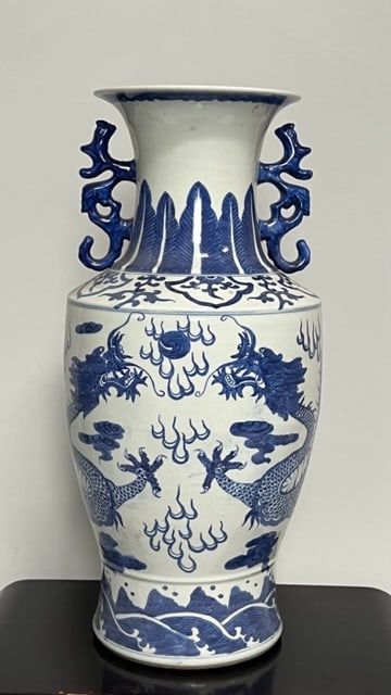CHINESE BLUE AND WHITE VASE: Depicting of two blue dragons chasing a flaming pearl, with dragon handles, and a six-character mark on the base. H: 21 1/4 in. W: 7 1/2 in.