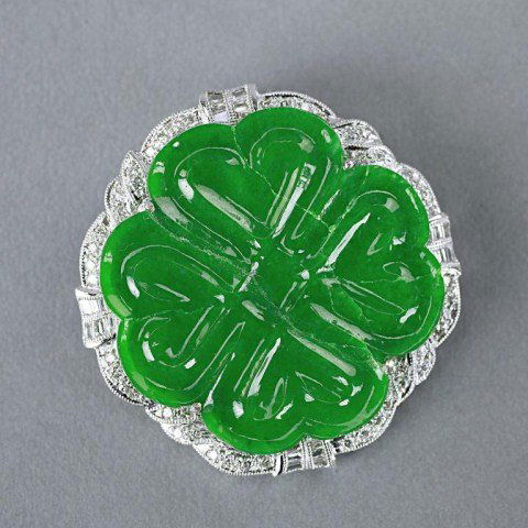 SPANISH IMPERIAL JADE FOUR LEAF CLOVER BROOCH: with GIA certificate. Set in white metal brooch, encrusted with round near colorless baguettes. H: 1 1/2 in.(4cm)