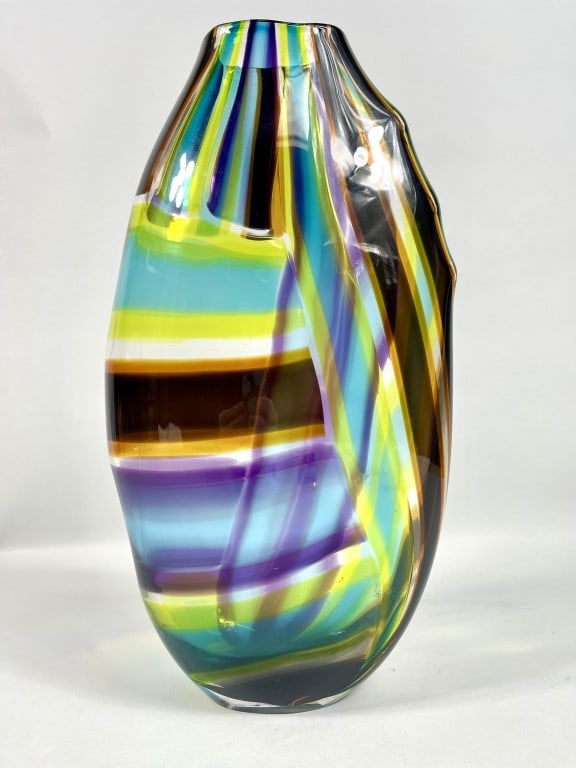 LEIGH TAYLOR WYATT, AMERICAN: A beautiful, tall glass vase that blends with light neon green, sky blue, orange, black and amethyst colors. Signed on bottom to read Leigh Wyatt '98.Property from the Estate of Dr. Stanley Block and 