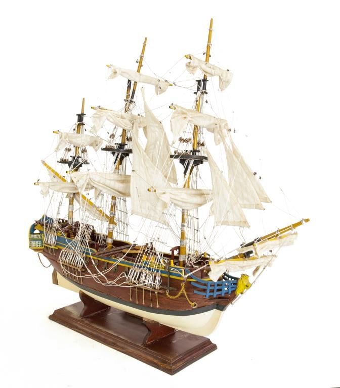 MAGNIFICENT WOODEN MODEL SHIP: The plaque on the base to read Gotheborg. Carved with great detail, painted a golden yellow and blue. H: 22 1/2 in., L: 25 in.