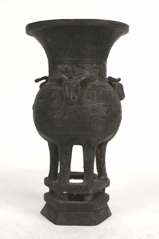 CHINESE BRONZE CENSER: Raised on six (6) slender legs on top of a plinth. With a globular body with a flaring mouth. Flanked by three goat heads on the shoulder, with carved taotie motif around the body. H: 13 in. W: 7 in.