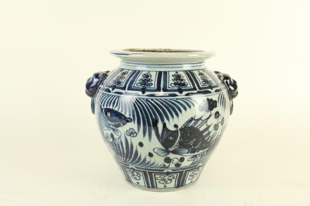 CHINESE BLUE AND WHITE PORCELAIN VASE: Painted all around the body with fishes. Flanked by two creature ring handles on the shoulder. H: 9 1/2 in.