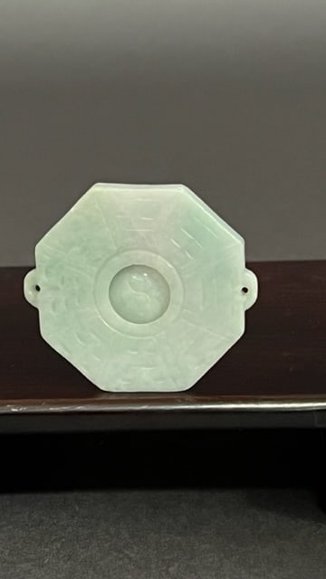 A CELADON-COLORED JADEITE OF A DISC (1 of 4)