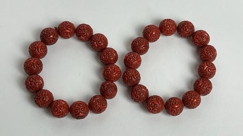 A SET OF TWO CARVED BEAD BRACELETS